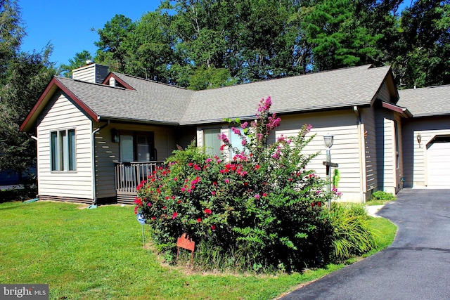 ranch-style home featuring a garage and a front yard