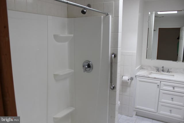 bathroom featuring a shower, vanity, and tile patterned floors