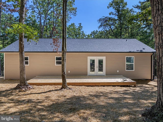 back of property featuring a wooden deck and french doors