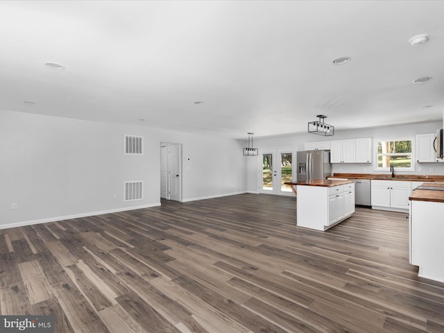 kitchen with dark wood-type flooring, sink, appliances with stainless steel finishes, and white cabinets