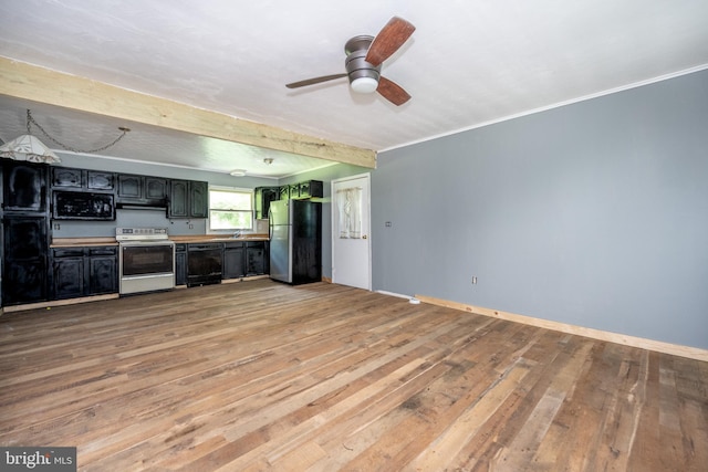 unfurnished living room featuring sink, ceiling fan, beamed ceiling, and light wood-type flooring