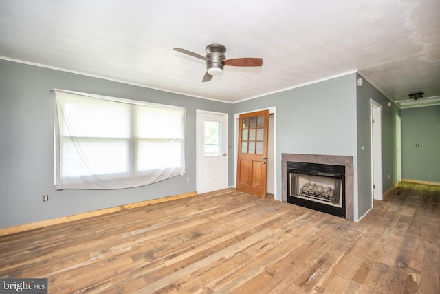 unfurnished living room with ceiling fan, hardwood / wood-style flooring, and ornamental molding