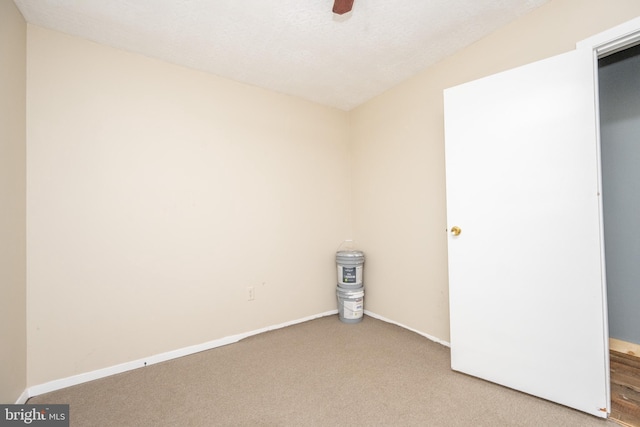 empty room featuring a textured ceiling and carpet flooring