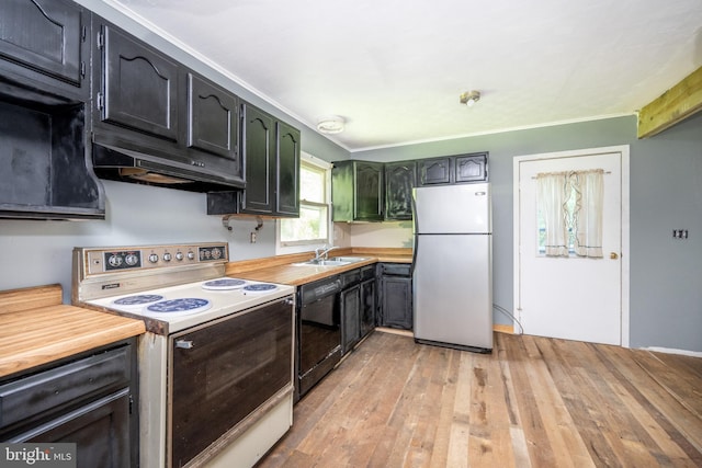 kitchen featuring sink, light hardwood / wood-style flooring, butcher block counters, and white appliances