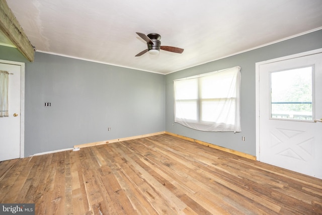 unfurnished room featuring ceiling fan, wood-type flooring, and ornamental molding