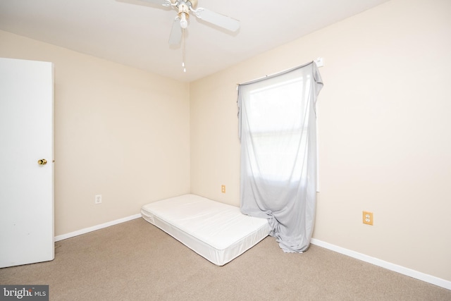 unfurnished bedroom with ceiling fan and carpet