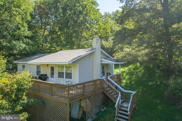 back of property featuring a wooden deck