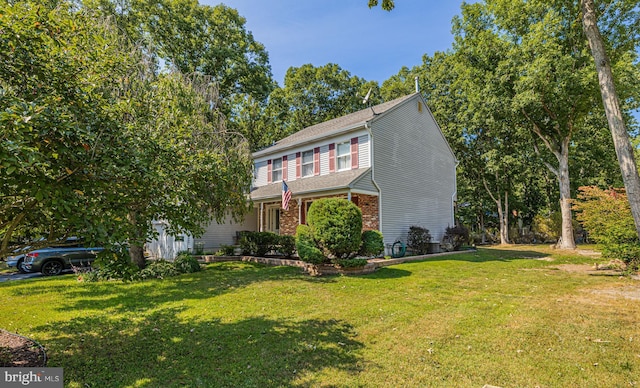 view of front of property featuring brick siding and a front yard