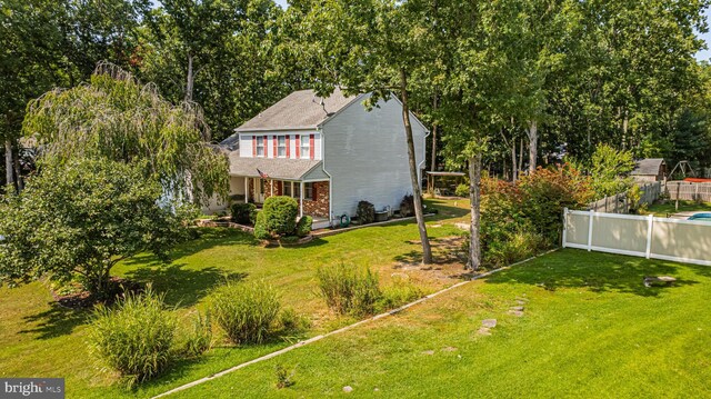 view of front of house with a porch and a front lawn