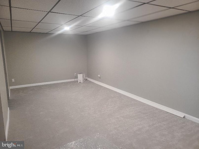 basement with a drop ceiling and carpet flooring