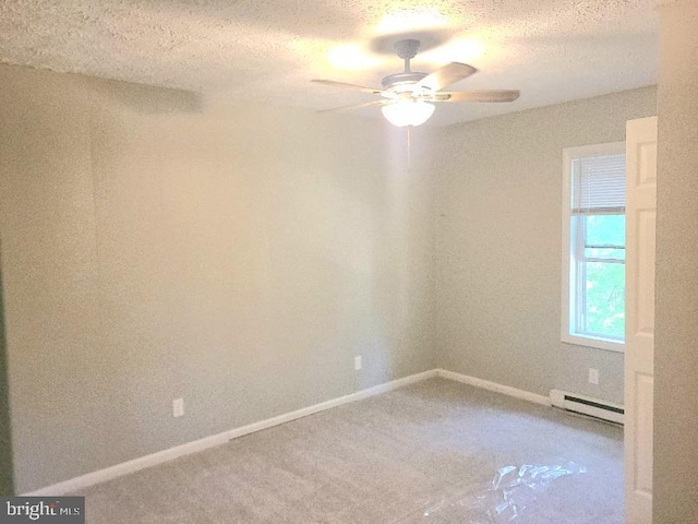 empty room featuring carpet flooring, a baseboard heating unit, a textured ceiling, and ceiling fan