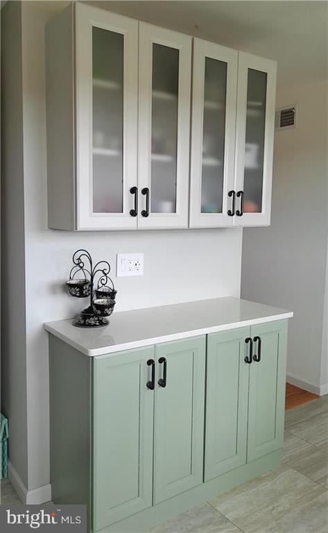 bar featuring green cabinetry