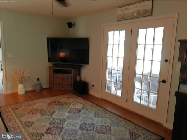 living area featuring wood finished floors and baseboards