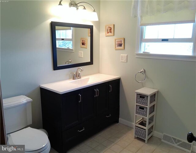 bathroom featuring tile patterned floors, vanity, and toilet