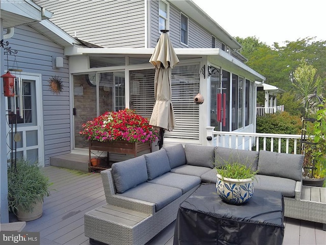 wooden terrace with a sunroom and an outdoor living space