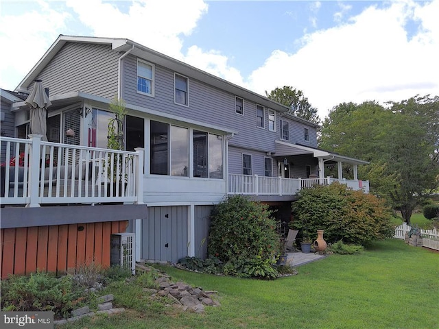 back of property featuring cooling unit and a lawn