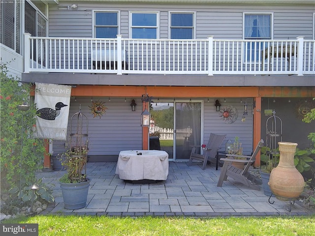 back of property with a balcony and a patio area