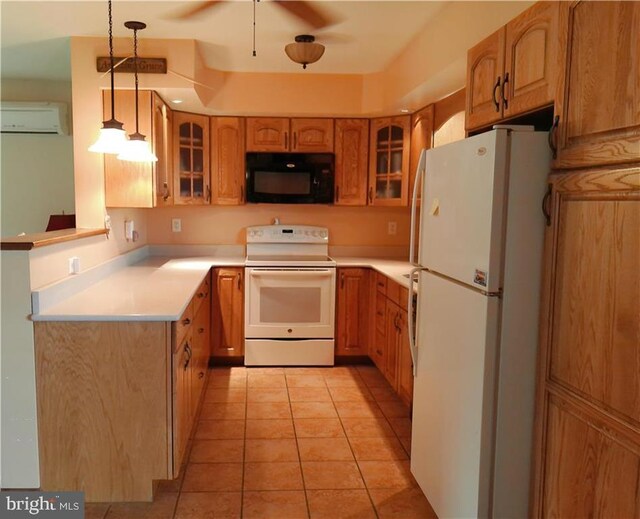 kitchen with hanging light fixtures, a wall unit AC, white appliances, and light tile patterned floors