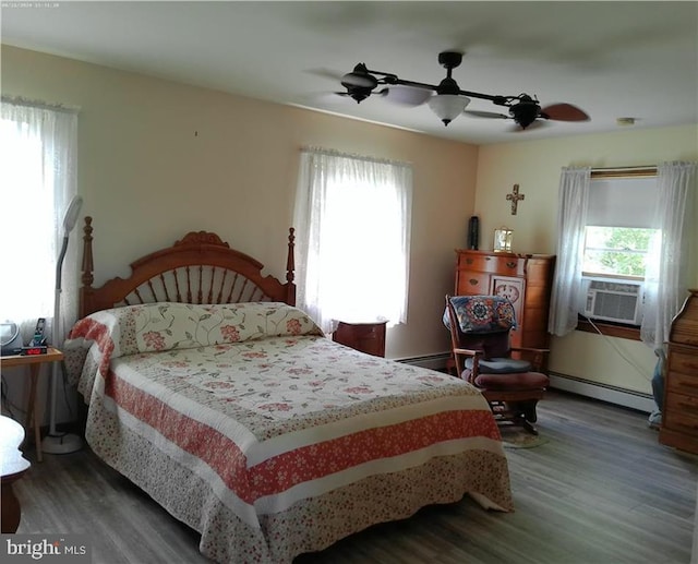 bedroom featuring ceiling fan, a baseboard radiator, cooling unit, and hardwood / wood-style flooring