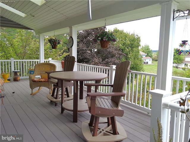 wooden deck with a ceiling fan