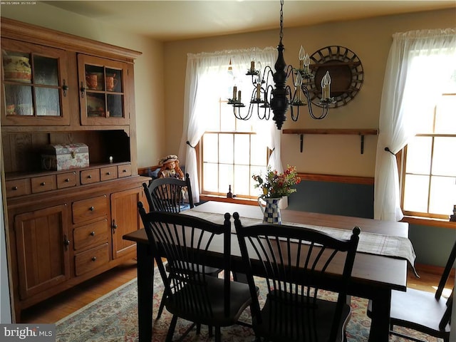 dining area with a notable chandelier and wood finished floors