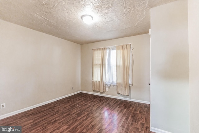 unfurnished room with wood-type flooring and a textured ceiling