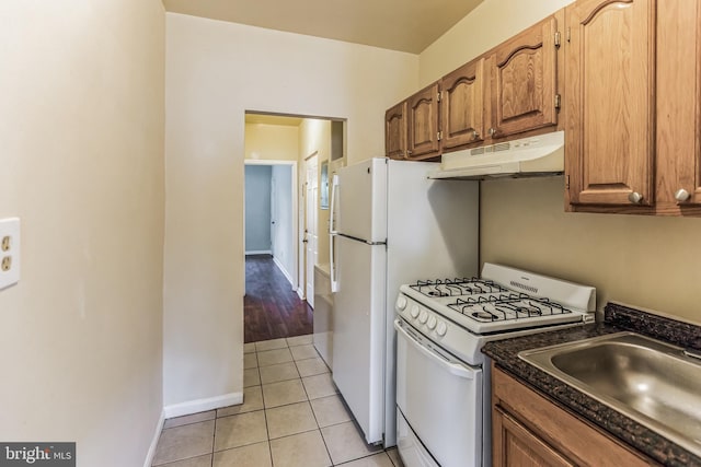 kitchen with sink, gas range gas stove, and light tile patterned flooring