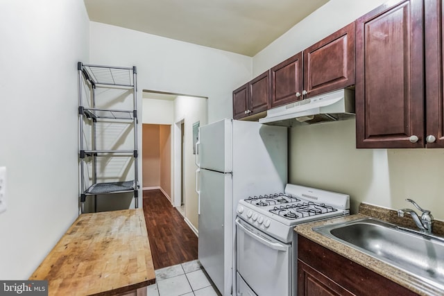 kitchen with sink, light wood-type flooring, and white range with gas cooktop