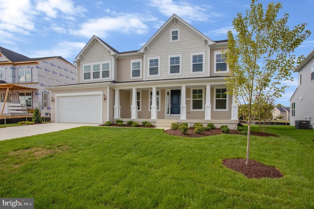 view of front of home with a front lawn, central air condition unit, a garage, and covered porch