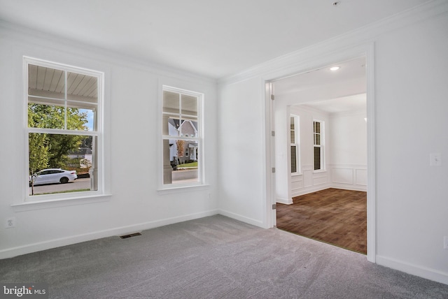 unfurnished room with carpet floors and crown molding