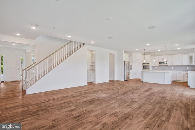 unfurnished living room featuring light wood-type flooring