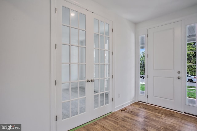 entrance foyer with french doors and wood-type flooring