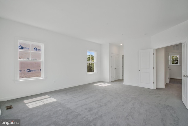 unfurnished bedroom featuring light carpet