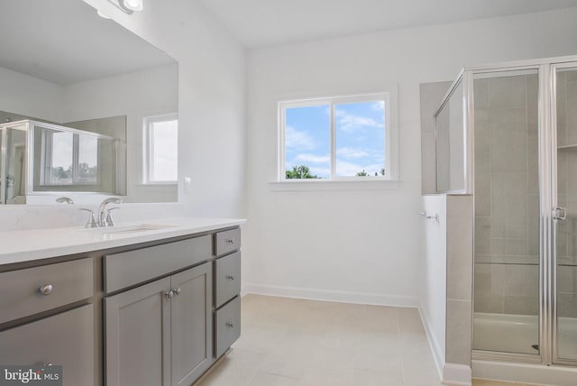 bathroom featuring an enclosed shower, vanity, and tile patterned floors