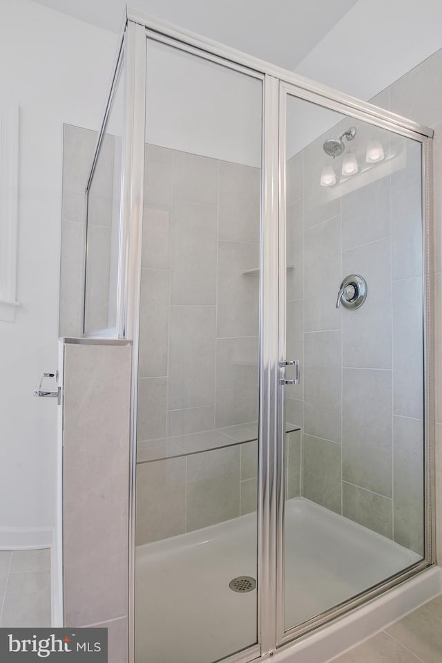 bathroom with tile patterned flooring and an enclosed shower