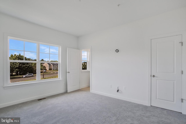 carpeted spare room with plenty of natural light