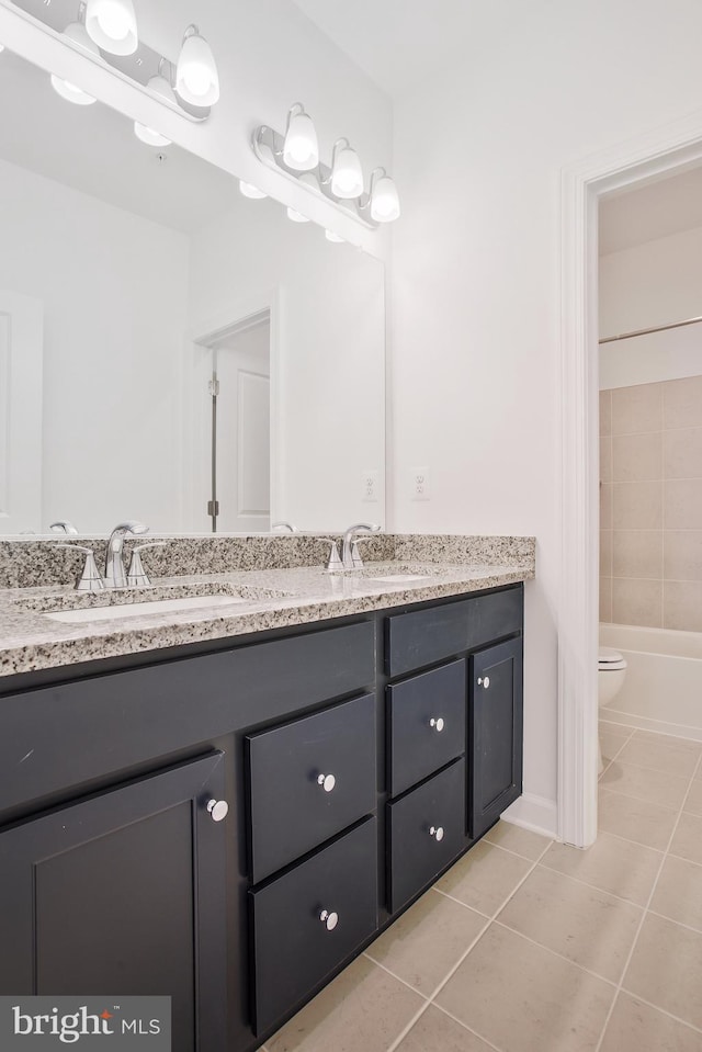 full bathroom with tiled shower / bath combo, tile patterned flooring, toilet, and vanity