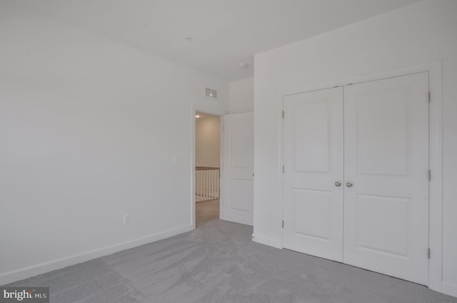 unfurnished bedroom with carpet floors and a closet