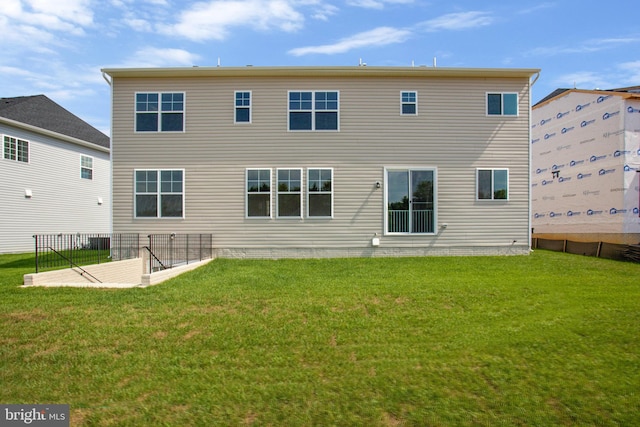 back of house featuring a lawn