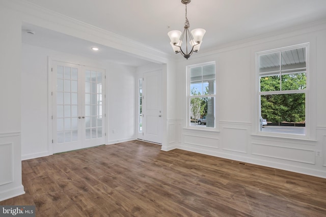 interior space with a notable chandelier, crown molding, french doors, and dark hardwood / wood-style floors