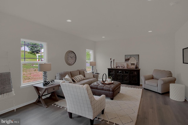 living area with plenty of natural light, light wood-type flooring, and baseboards