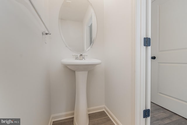 bathroom with hardwood / wood-style flooring