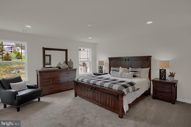 bedroom featuring light carpet, multiple windows, visible vents, and recessed lighting