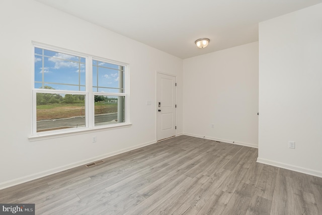 empty room with hardwood / wood-style flooring