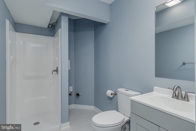 bathroom featuring a shower, tile patterned floors, vanity, and toilet