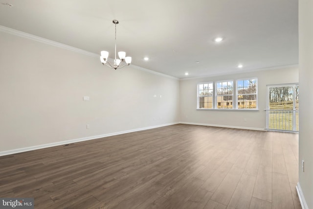 spare room with baseboards, dark wood-type flooring, and crown molding