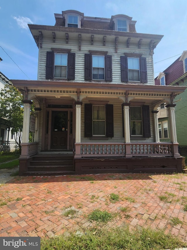 italianate home featuring covered porch