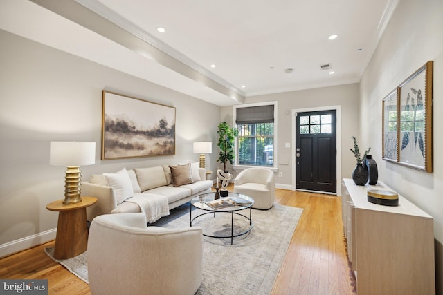 living room featuring light hardwood / wood-style flooring and ornamental molding