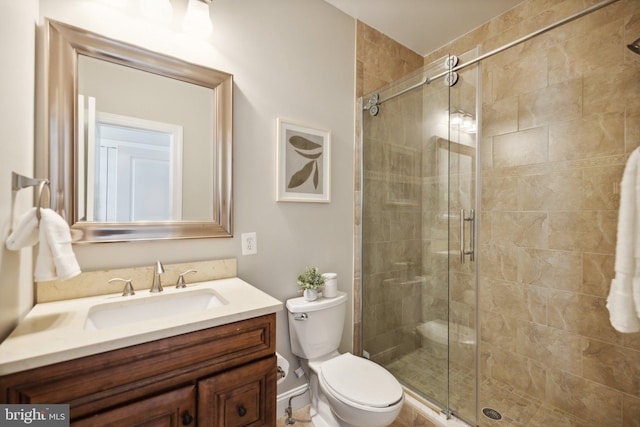 bathroom with vanity, toilet, and walk in shower