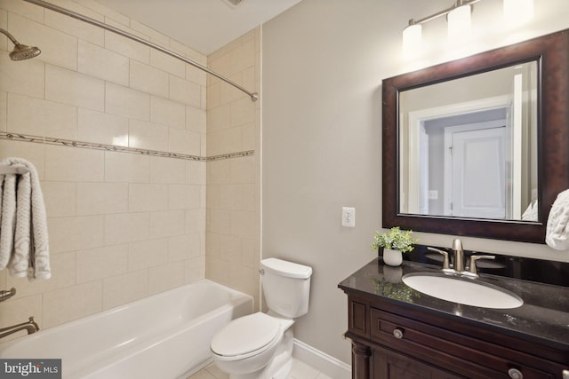 full bathroom featuring tiled shower / bath combo, vanity, toilet, and tile patterned floors